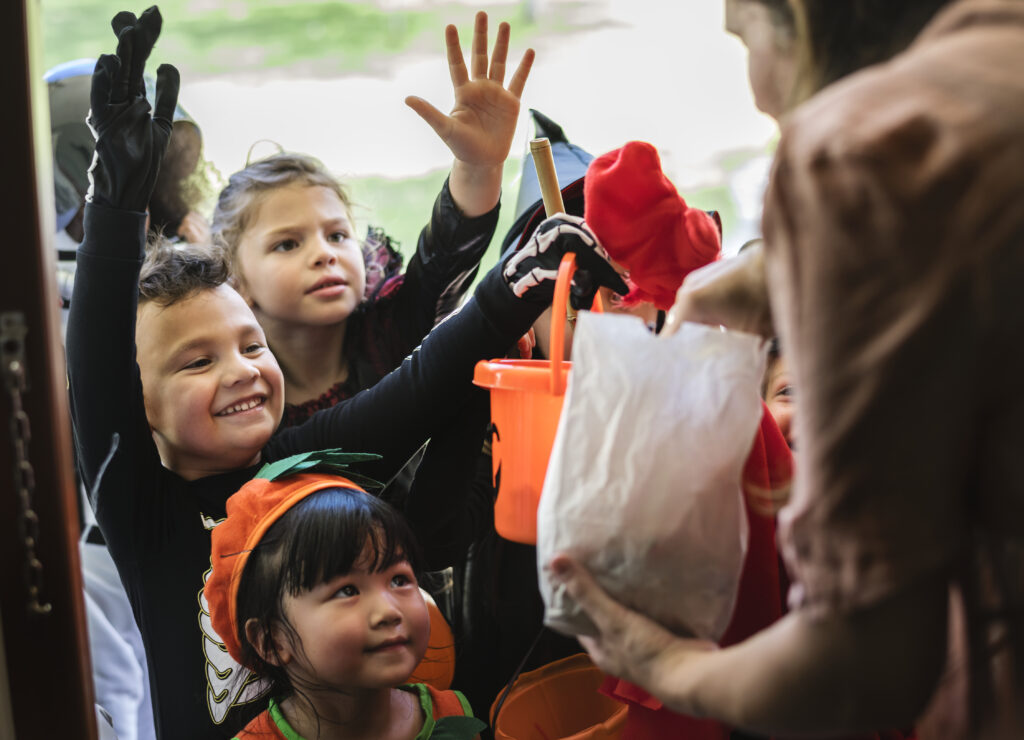 little children trick or treating on halloween